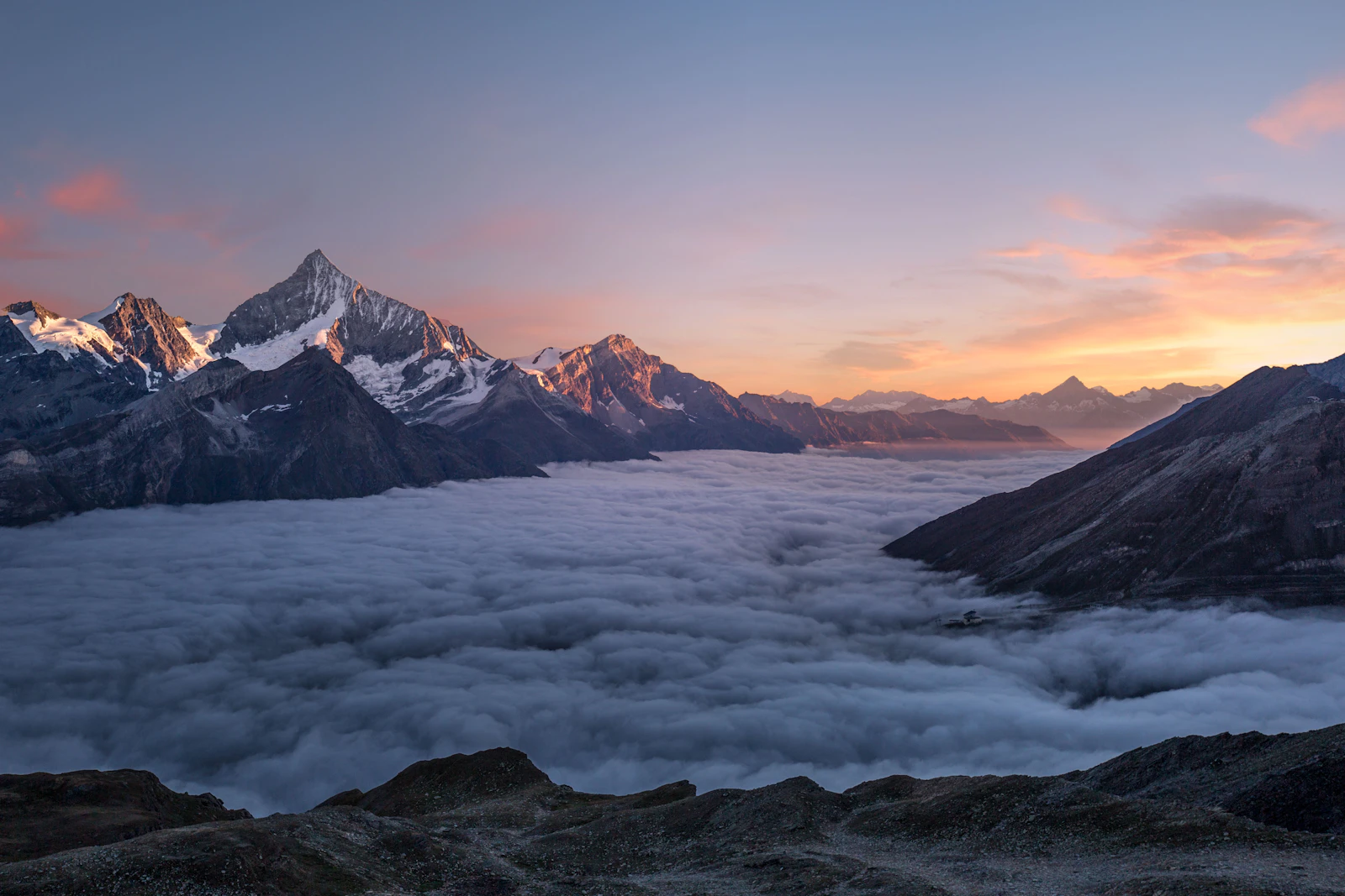 Snow-capped peaks above clouds (Himalayas).